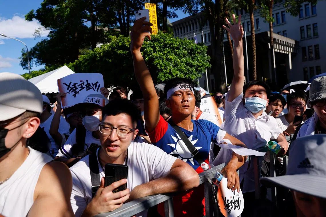 A man wears a T-shirt with the Taiwan flag design while attending a rally for legal reform and against high real estate prices in Taipei, Taiwan July 16, 2023. REUTERS/Ann Wang