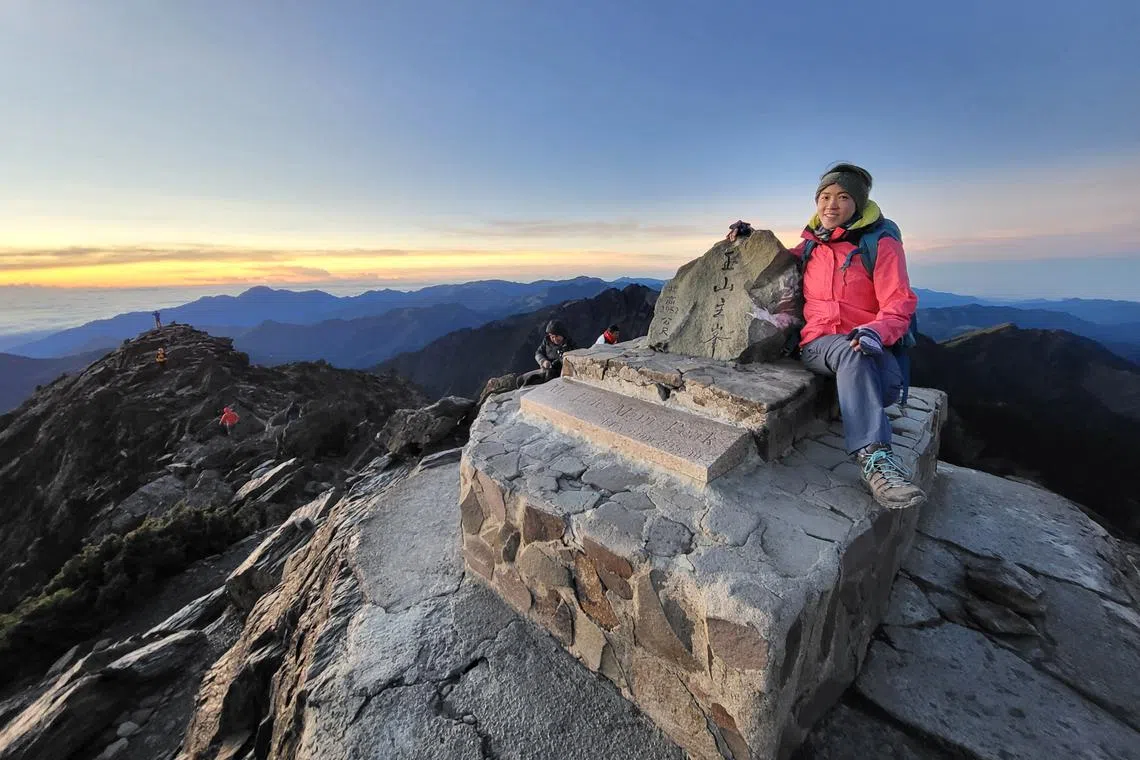 The writer enjoying the view at the summit of Yushan at sunrise.