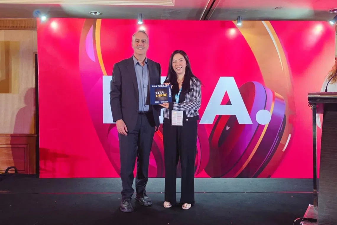 EMTM Radio’s head of product development, promotions and audience engagement Serene Lim (right) receiving the Asia Podcast Award from Mr Steve Ahern, Publisher of Radioinfo and Radiotoday, Australia.