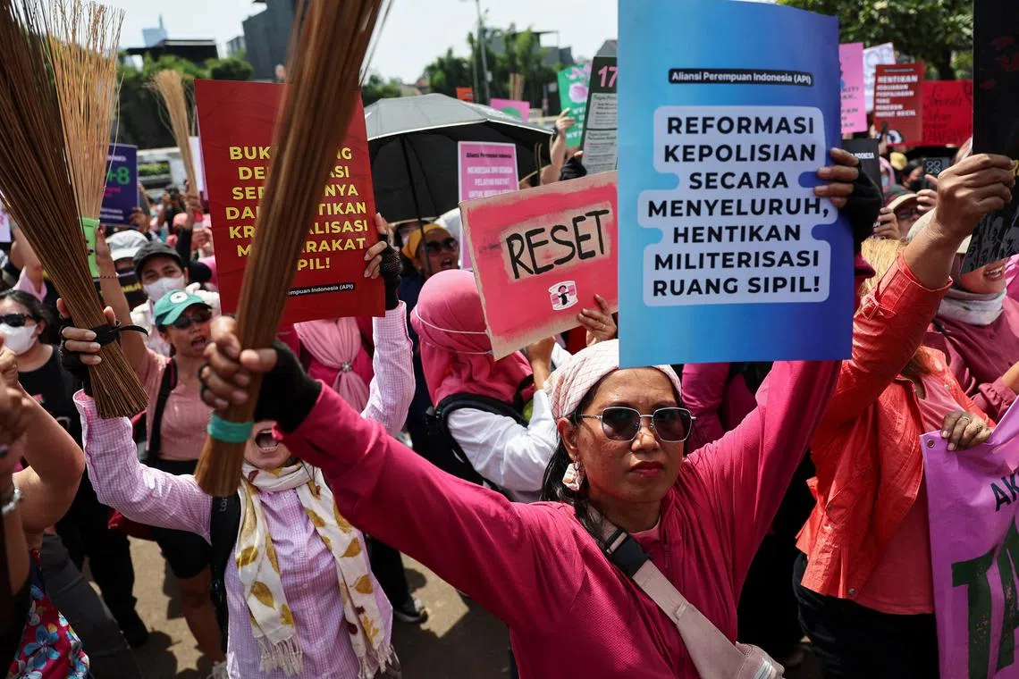 The women brandished brooms as a symbol of their calls for reform.