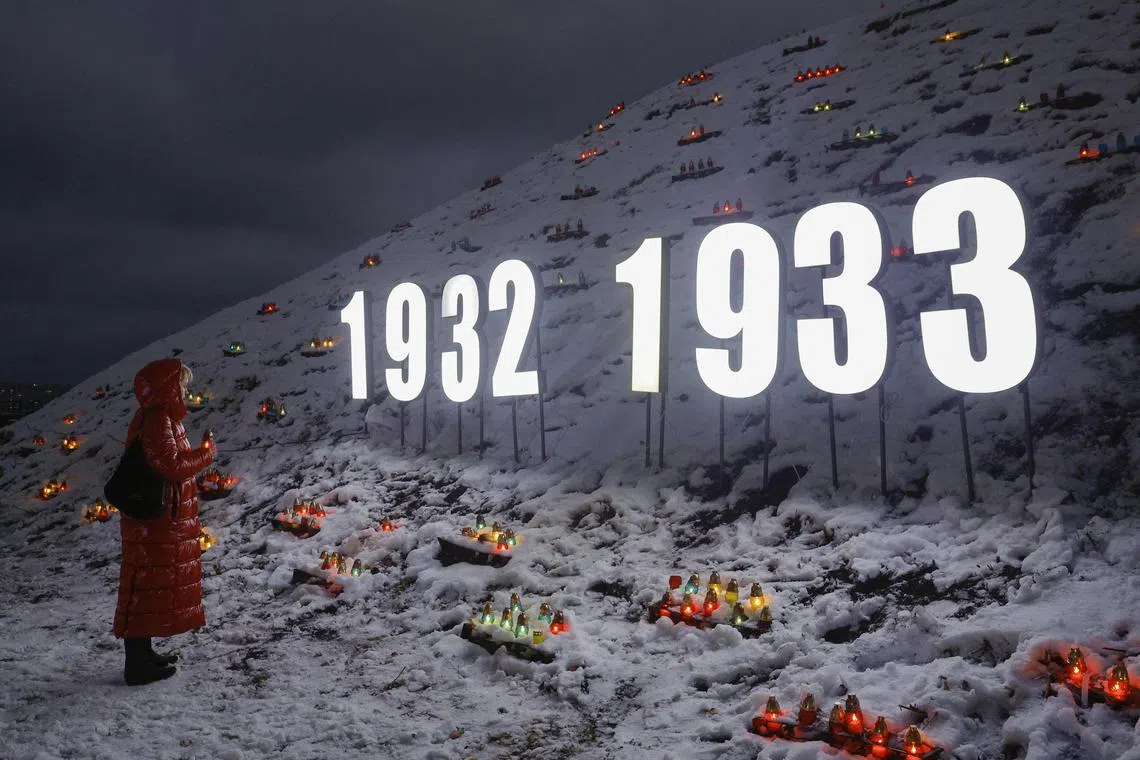 Ukrainians placed candles on a hill at the Holodomor Genocide Memorial complex of the National Museum in Kyiv, Ukraine, on Nov 23, 2024, amid the ongoing Russian invasion. The victims of the Holodomor, meaning 'death by starvation' in Ukrainian, are traditionally commemorated on the last Saturday of November.