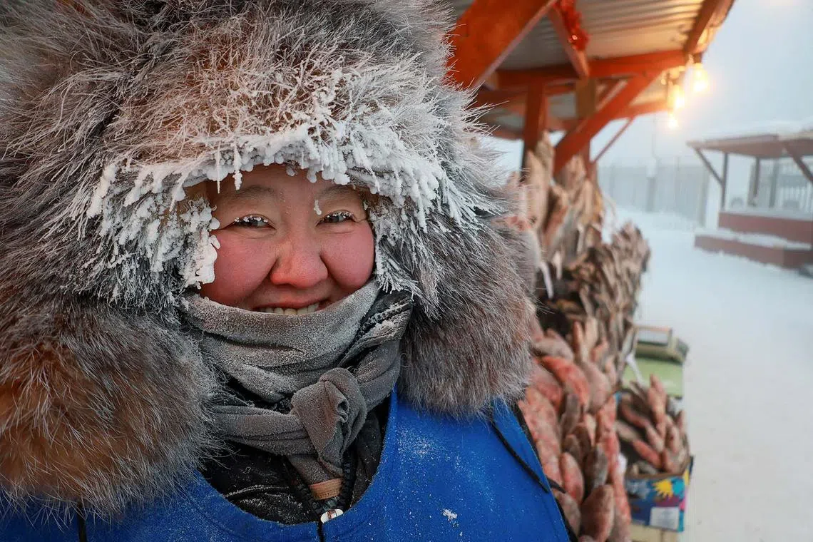 Vendor Nyurgusun Starostina, 47, poses for a picture at an open-air market on a frosty day in Yakutsk, Russia, December 5, 2023. Temperatures in parts of the Sakha Republic, also known as Yakutia and located in the northeastern part of Siberia, went below minus 50 degrees Celsius (minus 58 degrees Fahrenheit) on December 5. REUTERS/Roman Kutukov