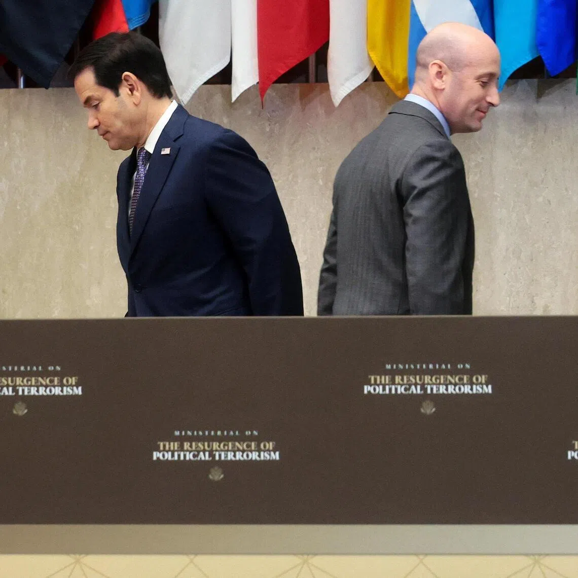 US Secretary of State Marco Rubio (left) crossing paths with fellow speaker and White House deputy chief of staff Stephen Miller at the State Department event on July 16.