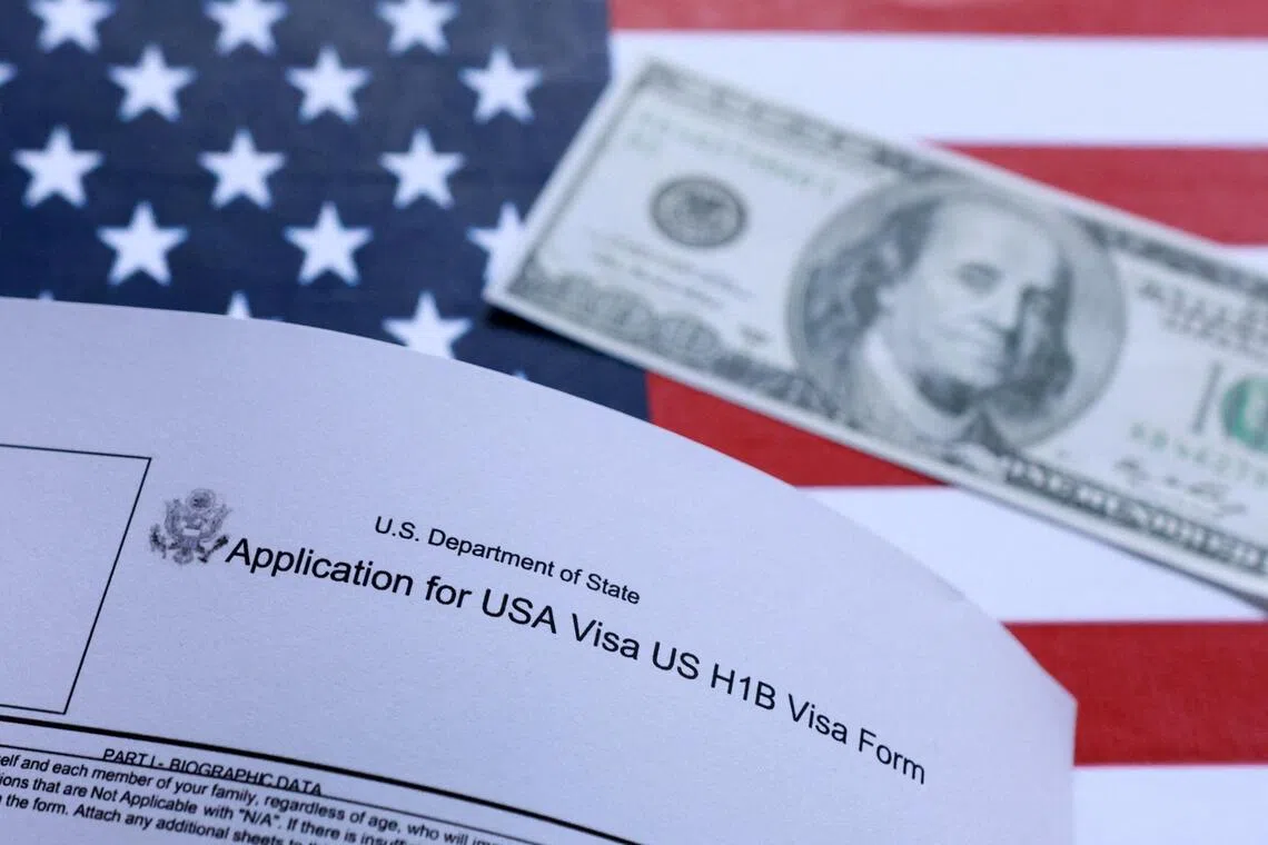 U.S. flag, mock passport, 100 dollar banknote and H-1B visa application form are seen in this illustration taken September 26, 2025. REUTERS/Dado Ruvic/Illustration 