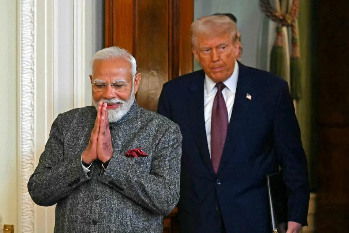 TOPSHOT - US President Donald Trump and Indian Prime Minister Narendra Modi arrive to hold a joint press conference in the East Room of the White House in Washington, DC, on February 13, 2025. (Photo by ANDREW CABALLERO-REYNOLDS / AFP)