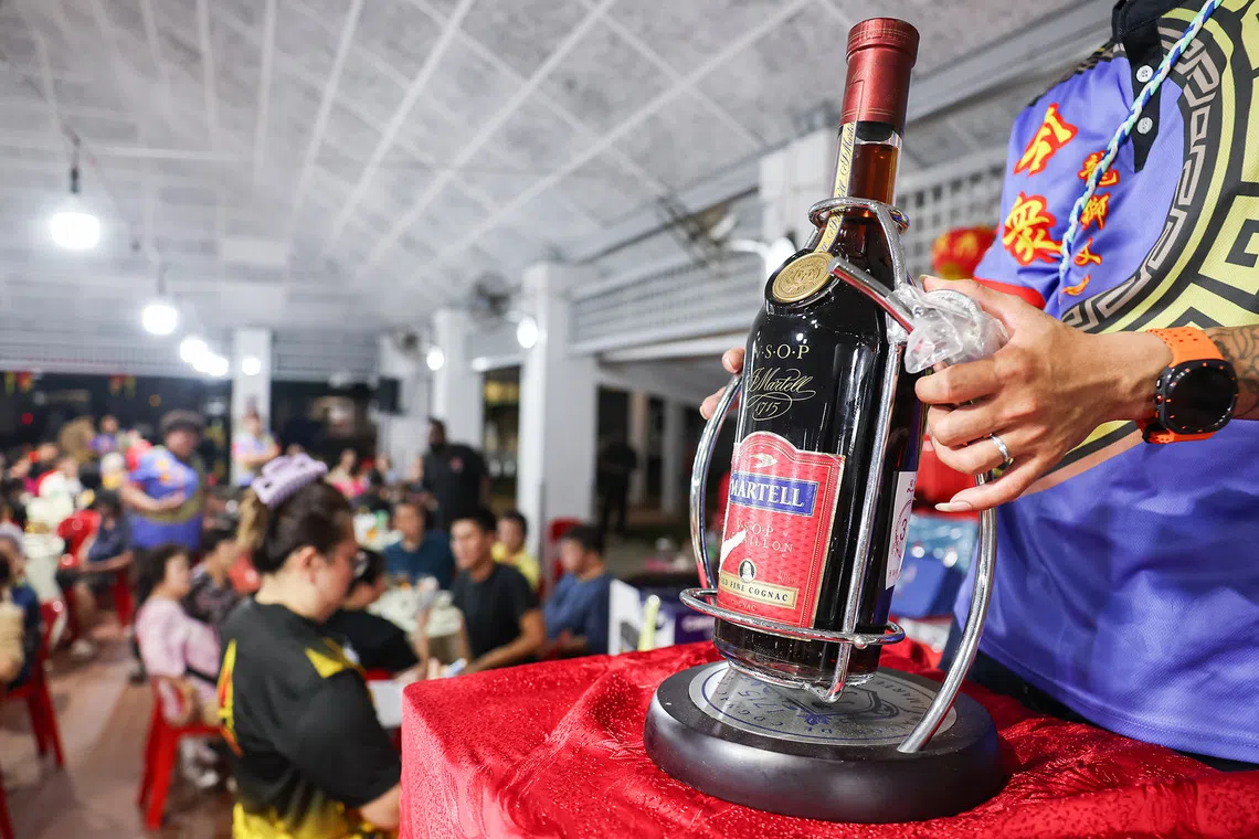 Close-up of a 3L bottle of Martell VSOP cognac being auctioned during the Hungry Ghost Festival dinner auction in Toa Payoh on Aug 23, 2026. ST PHOTO: BRIAN TEO