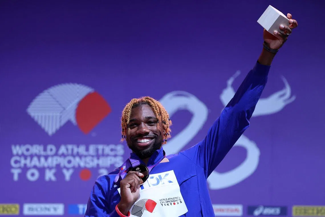 Bronze medallist Noah Lyles of the U.S. celebrates on the podium in the 100m.