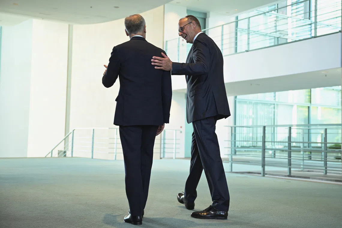 Canadian Prime Minister Mark Carney and German Chancellor Friedrich Merz walk on the day they held a press conference  at the Chancellery in Berlin, Germany August 26, 2025. REUTERS/Annegret Hilse