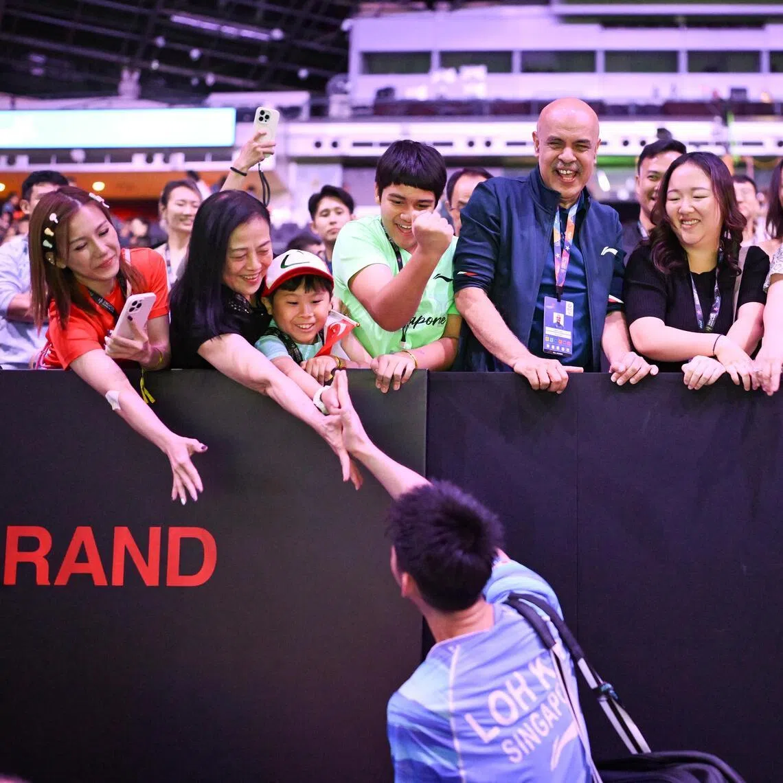 Singapore's Loh Kean Yew being congratulated by supporters after winning the KFF Singapore Badminton Open men's singles semi-final against Japan's Koki Watanabe at the Singapore Indoor Stadium on May 30.