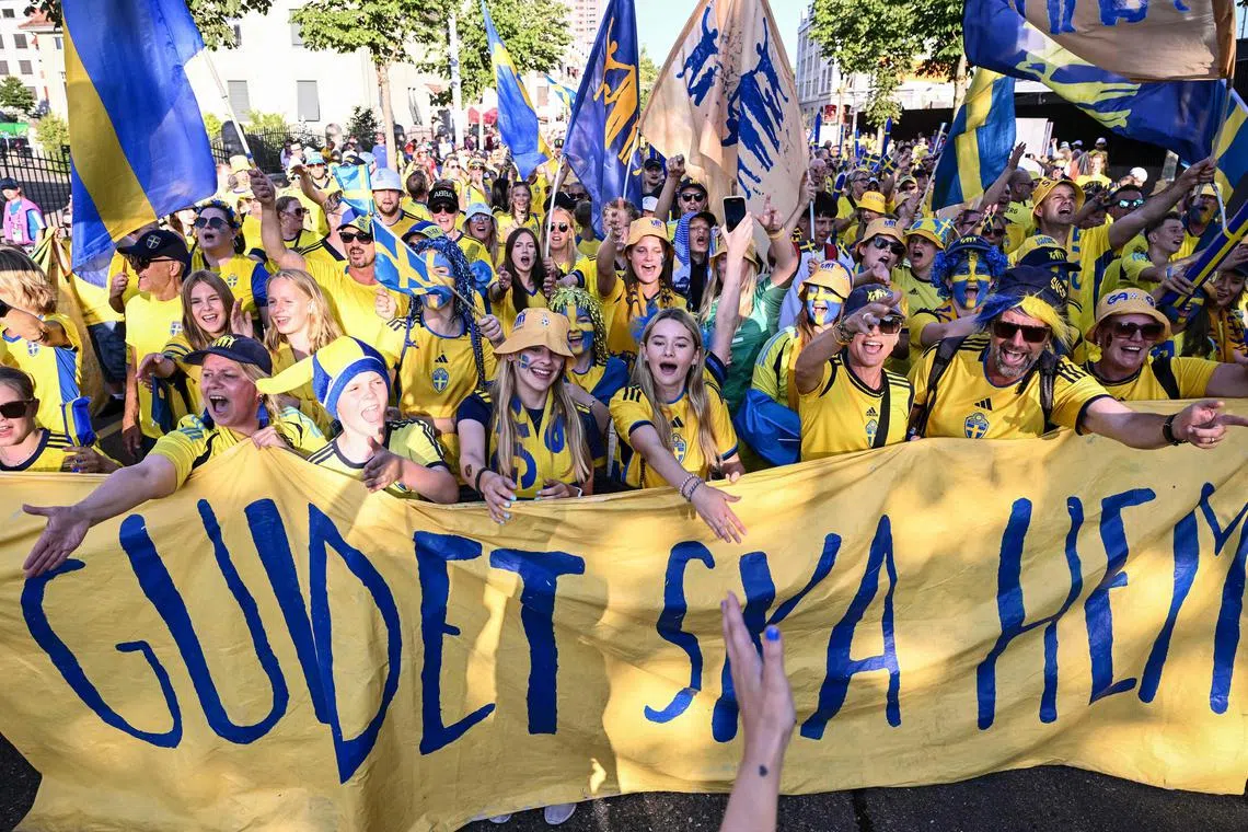 Swedish supporters' group the Soft Hooligans cheer for their team ahead of the Women's Euro 2025 Group C football match between Sweden and Germany outside the Letzigrund Stadium in Zurich, on July 12, 2025. Swedish supporters' group the Soft Hooligans have brought their chants, drums and message of inclusion to Switzerland to support their national team in the 2025 Euros, to promote good vibes in the stands and better conditions for women's football. 