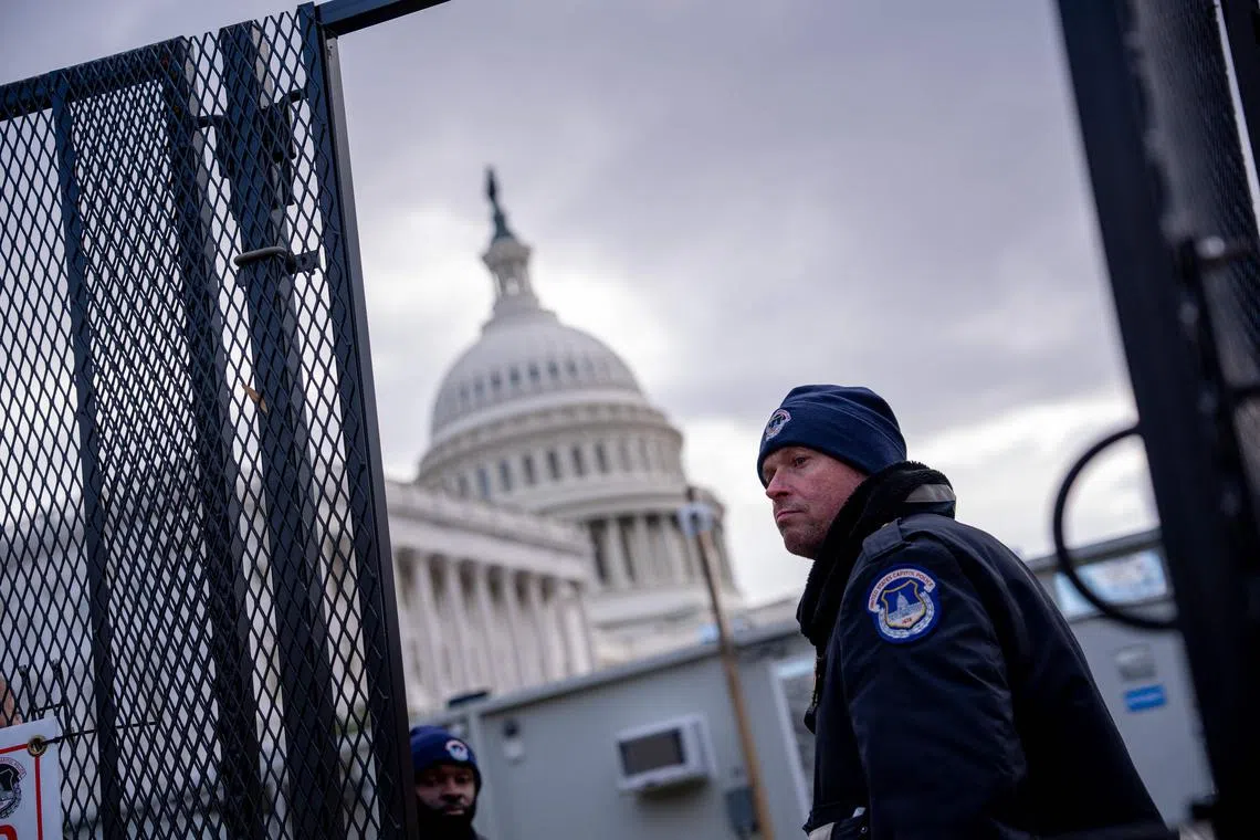 The dome of the US Capitol Building can be seen through temporary fencing in Washington, on Jan 2, ahead of US President-elect Donald Trump's inauguration.