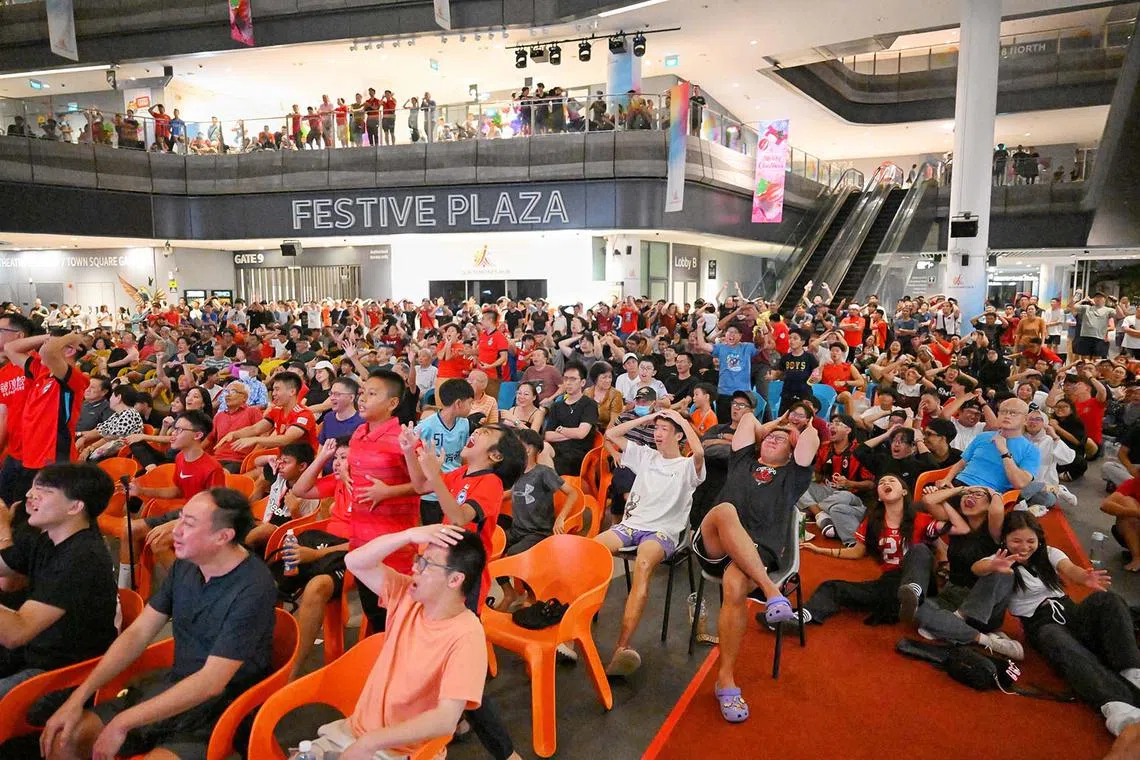 A few hundred Singapore football fans watching a live broadcast of the ASEAN Mitsubishi Electric Cup against Vietnam at Our Tampines Hub on Dec 26, 2024.