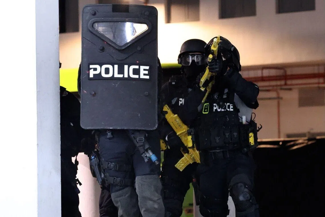 The police's Special Operations Command arriving in response to a simulated terrorist scenario in a shopping mall at the Home Team Tactical Centre.