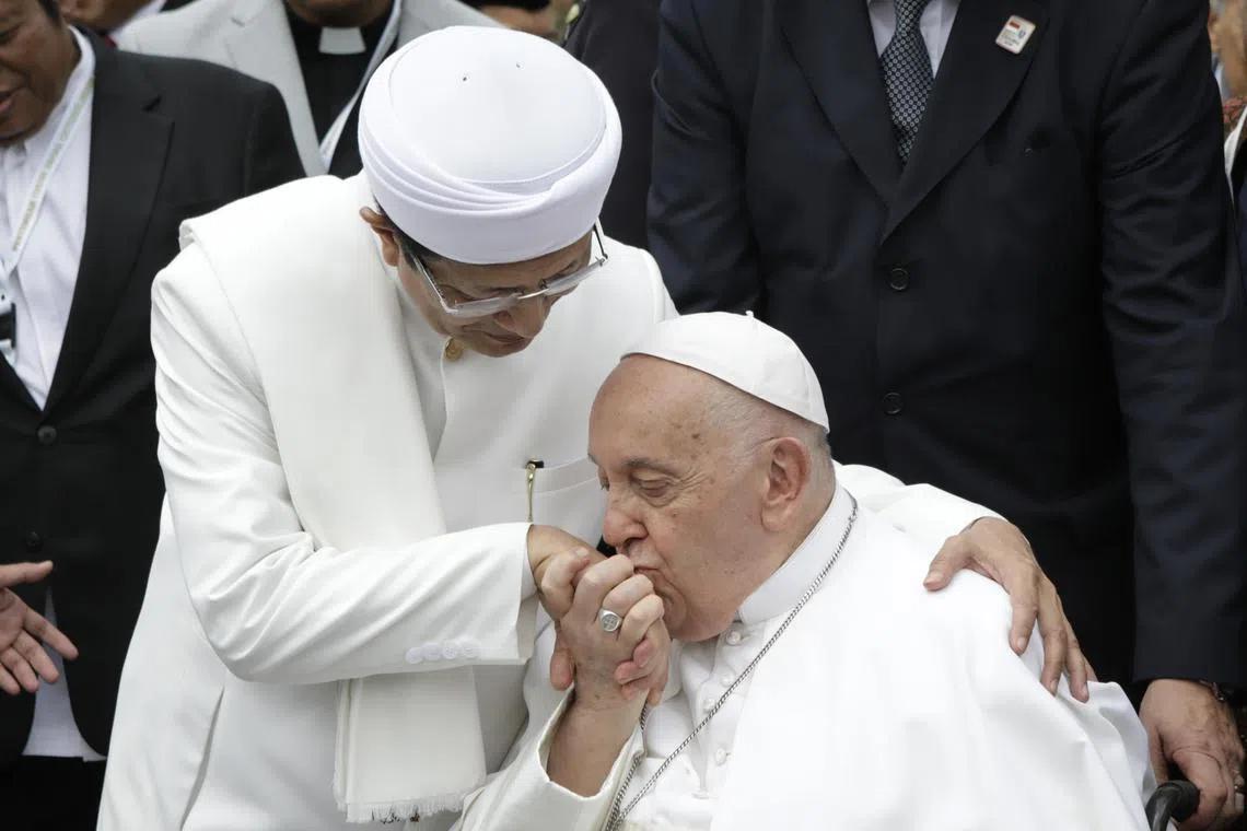 Pope Francis kisses the hand of the Grand Imam of Istiqlal Mosque Nasaruddin Umar after an inter-religious meeting with religious leaders at the Istiqlal Mosque in Jakarta, Indonesia, on Sept 5, 2024. 