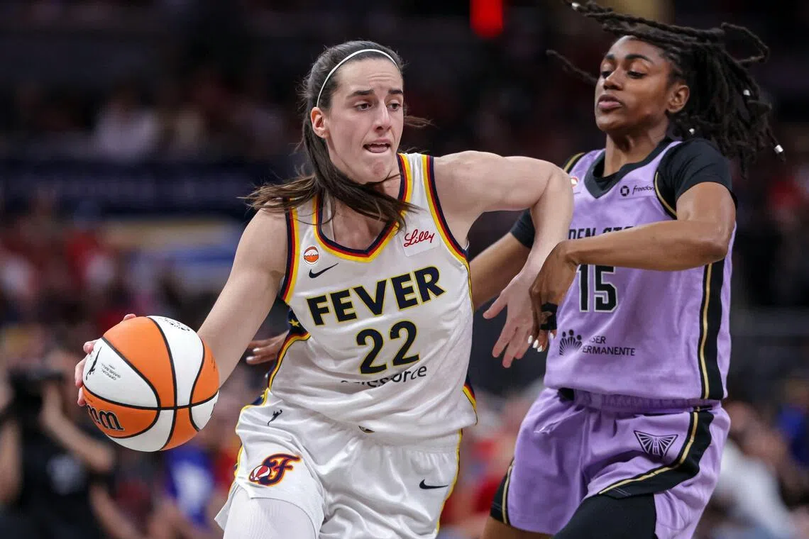 Indiana Fever’s Caitlin Clark dribbling past Tiffany Hayes of the Golden State Valkyries in Indianapolis, Indiana, on July 15.