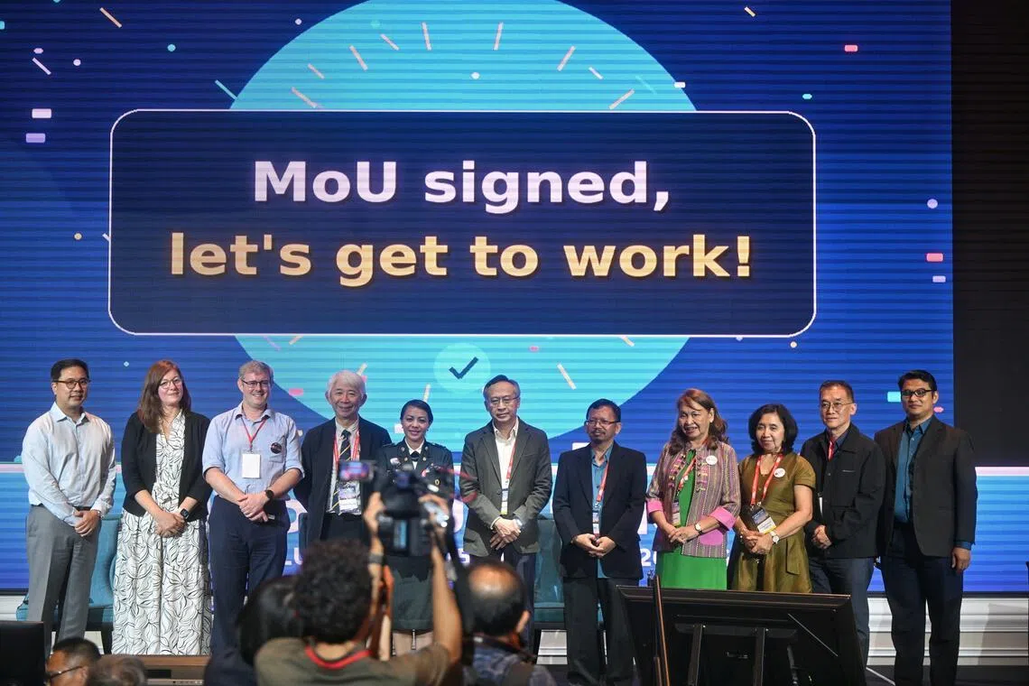 Representatives from the various regional groups taking a photo after signing the MoU at the 9th Asia Dengue Summit at Orchard Hotel on June 15.