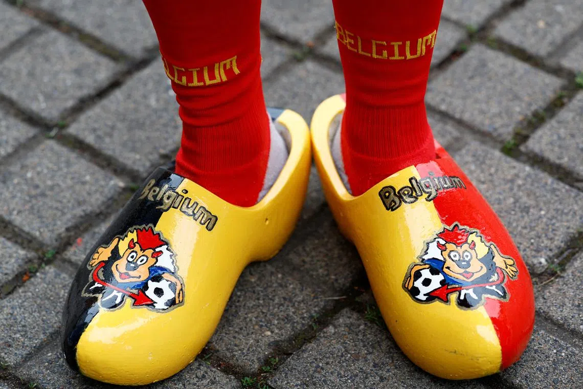 Soccer Football - Euro 2024 - Group E - Belgium v Romania - Cologne Stadium, Cologne, Germany - June 22, 2024 Wooden clogs worn by a Belgium fan are pictured outside the stadium before the match REUTERS/Piroschka Van De Wouw