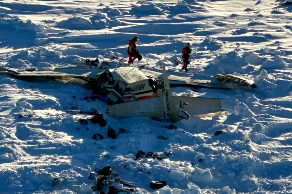 Emergency responders inspect the wreckage of a plane that went missing with 10 people on board on Feb 6.