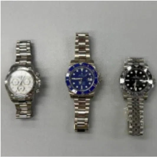 Italian national Singh Deepak tried to cheat a retailer by exchanging his purportedly counterfeit watch (right) with three genuine Rolex watches (left).
