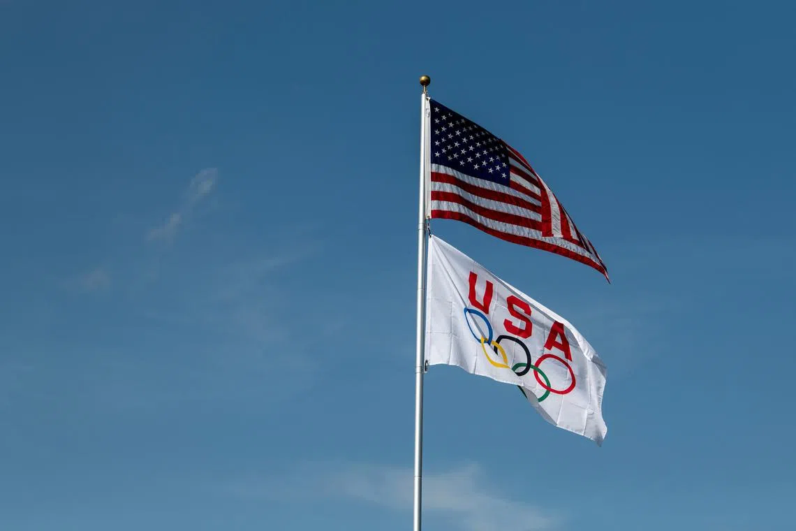 A U.S. and a USA Olympic flag are flown at the family home of U.S. swimmer Hunter Armstrong on the day of his Olympic debut at the 2021 Olympic Games, in Dover, Ohio, U.S., July 25, 2021. Picture taken July 25, 2021. REUTERS/Gaelen Morse/File Photo