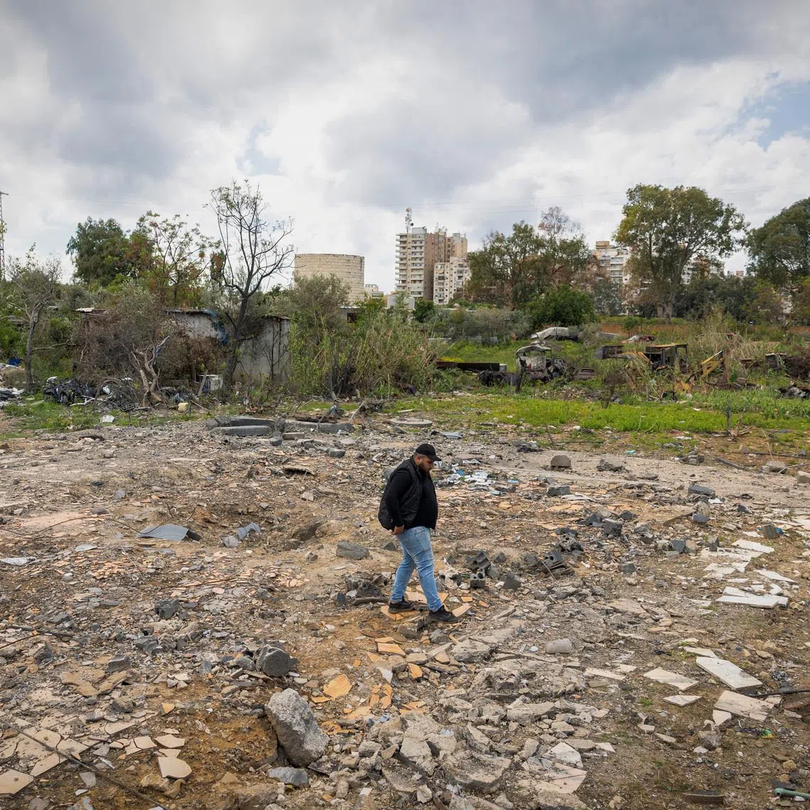 Hussein Saleh, 34, walks on the rubble of his house destroyed in an Israeli airstrike, which killed members of his family, amid escalating hostilities between Israel and Hezbollah, as the U.S.-Israeli conflict with Iran continues, in Tyre, Lebanon, April 7, 2026. REUTERS/Adnan Abidi