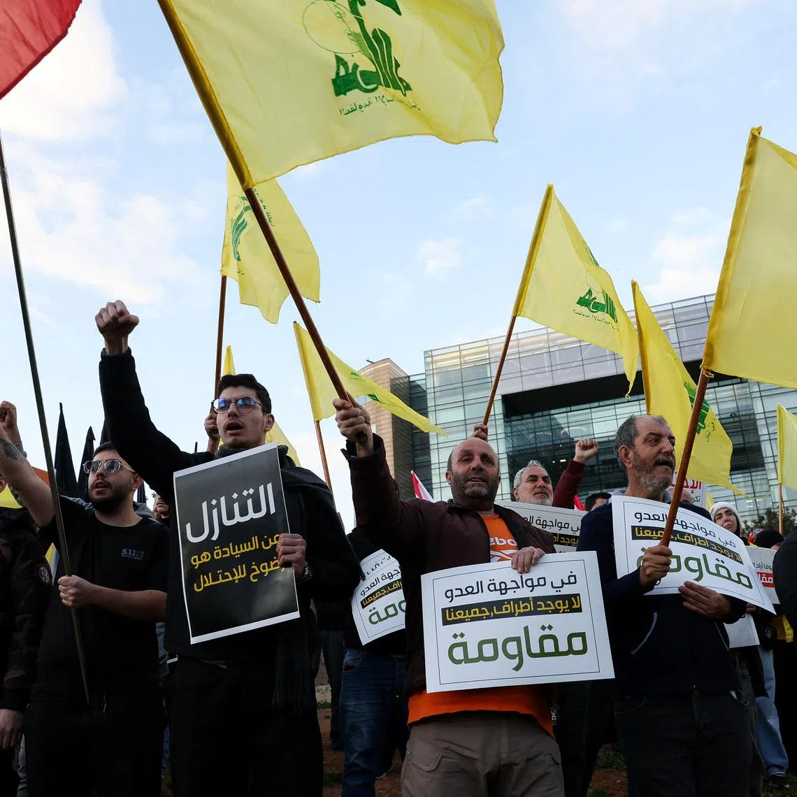 Protesters hold placards and Hezbollah flags during a demonstration condemning recent Israeli military actions in Lebanon, in Beirut, Lebanon February 4, 2026. REUTERS/Mohamed Azakir