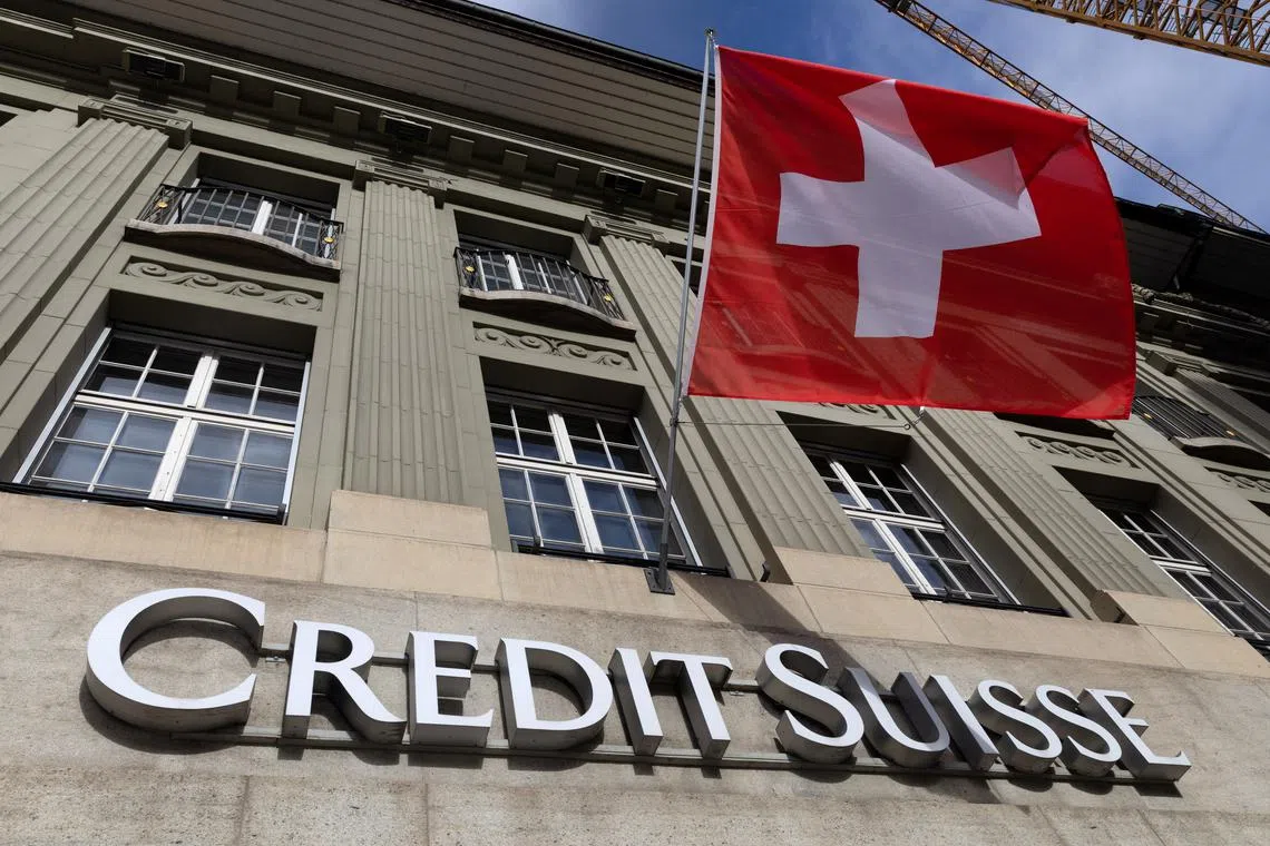 A Swiss flag is pictured above a logo of Swiss bank Credit Suisse in Bern, Switzerland, November 15, 2023. REUTERS/Denis Balibouse
