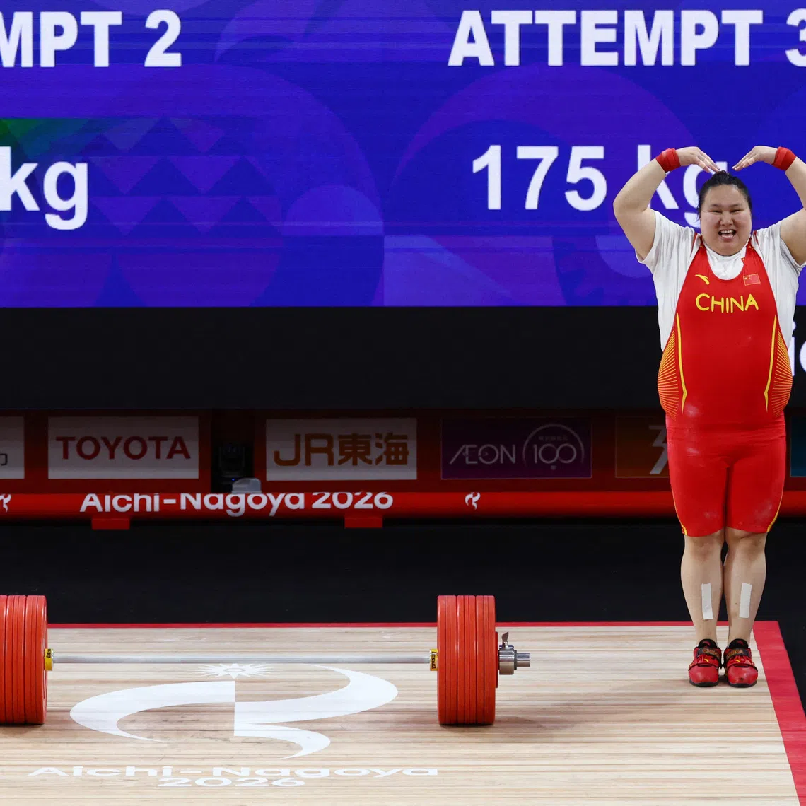 Asian Games - Aichi-Nagoya 2026 - Weightlifting - Nagoya City Trade and Industry Center, Nagoya, Japan - September 29, 2026 Gold medallist China's Li Wenwen celebrates winning the Women's +86kg REUTERS/Edgar Su
