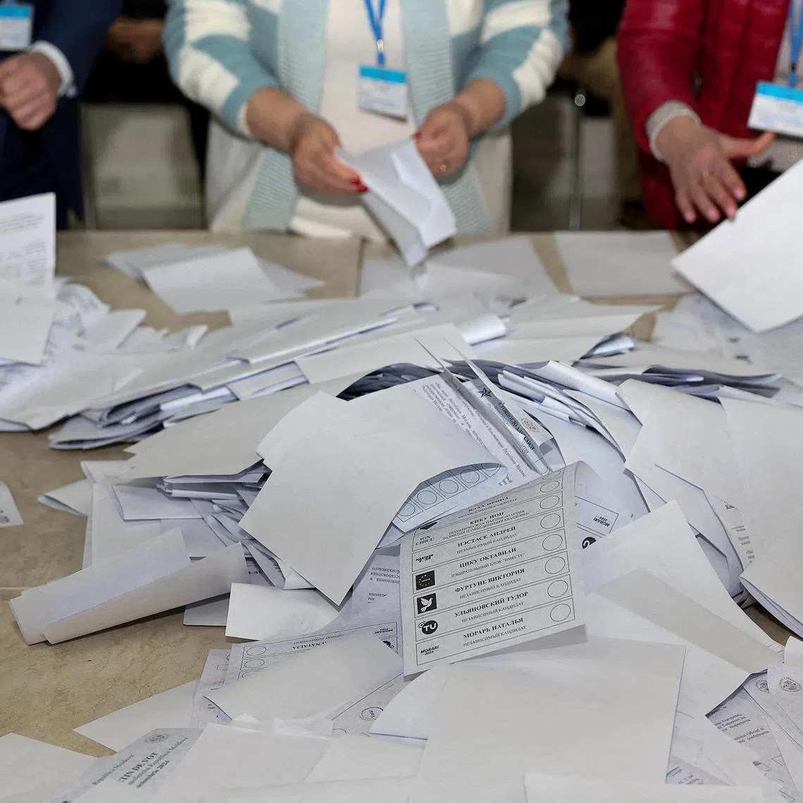 Members of an electoral commission count votes after polling stations closed in the course of Moldova's presidential election and a referendum on joining the European Union, in Chisinau, Moldova October 20, 2024. REUTERS/Stringer/File Photo