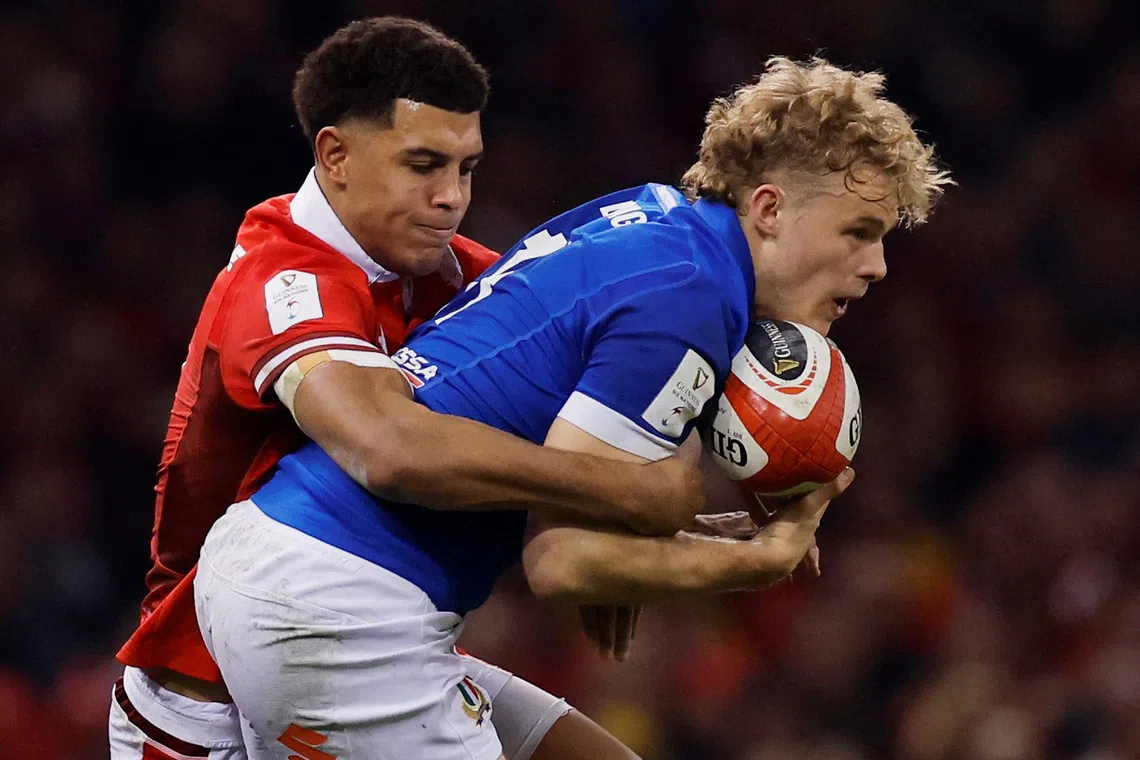 FILE PHOTO: Rugby Union - Six Nations Championship - Wales v Italy - Principality Stadium, Cardiff, Wales, Britain - March 16, 2024 Italy's Louis Lynagh in action with Wales' Rio Dyer Action Images via Reuters/Andrew Couldridge/File Photo