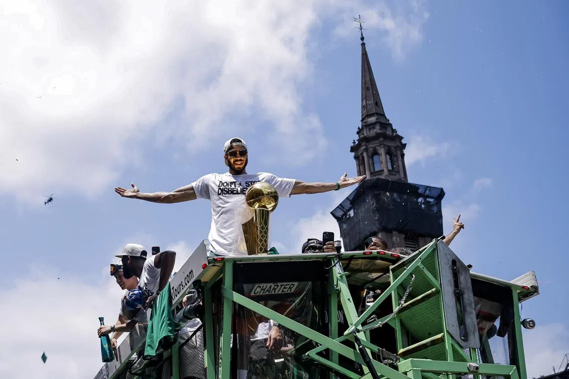 Boston Celtics forward Jayson Tatum with the Larry O'Brien trophy during the team's championship parade.