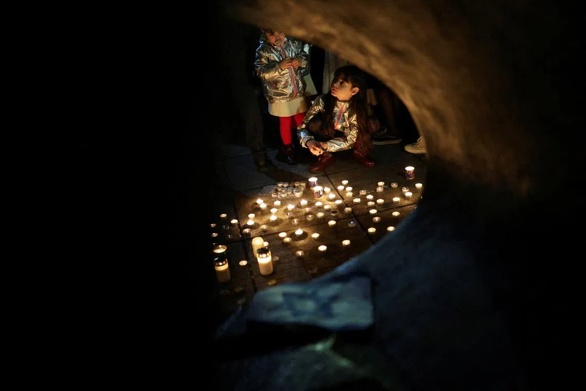 People attending a candlelight vigil for remembrance and solidarity with Israel in front of the Monument of the Salvation of the Bulgarian Jews in Sofia, Bulgaria, Oct 10.