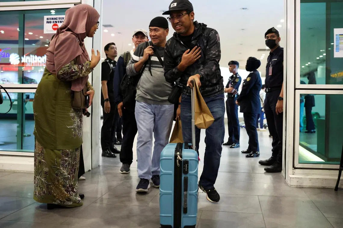 Malaysians, evacuated from deadly violence in Bangladesh, arrive at Kuala Lumpur International Airport Terminal 2 on July 23.