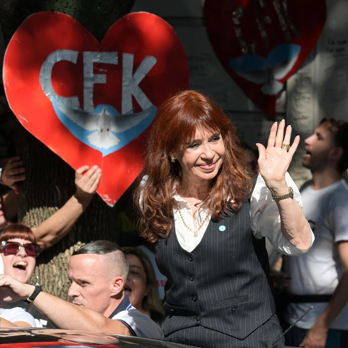 Argentina's former President Cristina Fernandez de Kirchner waves outside her residence, where she is currently staying under house arrest, on the day of a hearing in the \"Causa Cuadernos\" corruption trial, after being summoned to testify following the rejection of defence motions seeking to nullify the proceedings, in Buenos Aires, Argentina, March 17, 2026. REUTERS/Martin Cossarini