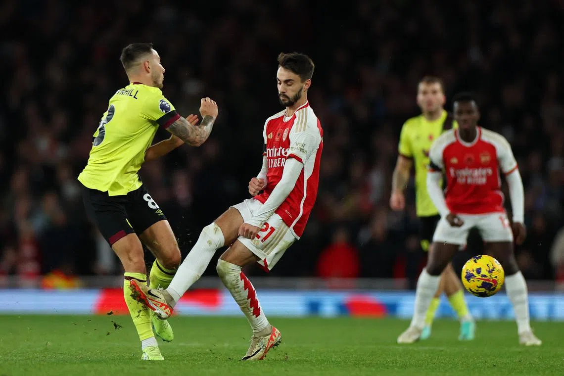 Arsenal's Fabio Vieira fouls Burnley's Josh Brownhill and is subsequently shown a red card by referee Michael Oliver.