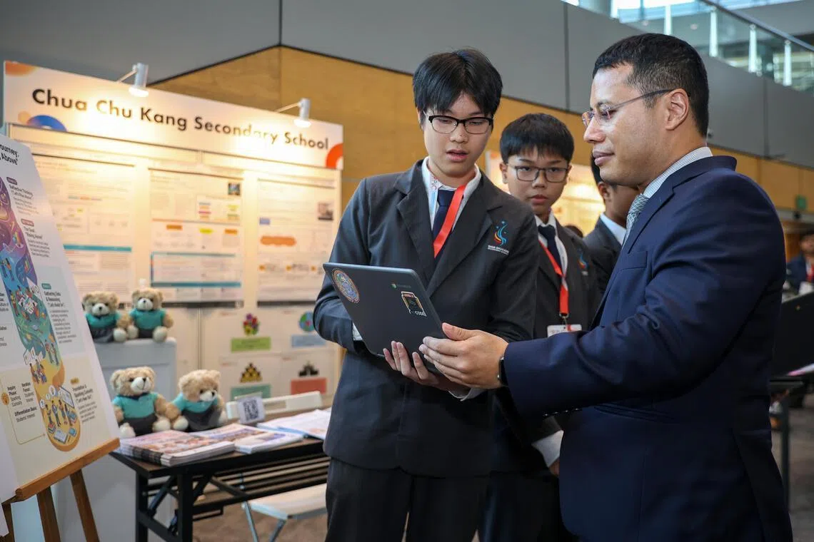 Minister for Education Desmond Lee speaks to Ow Jun Yi Gil, 15, a Secondary Three student from Choa Chu Kang Secondary School on June 2.
