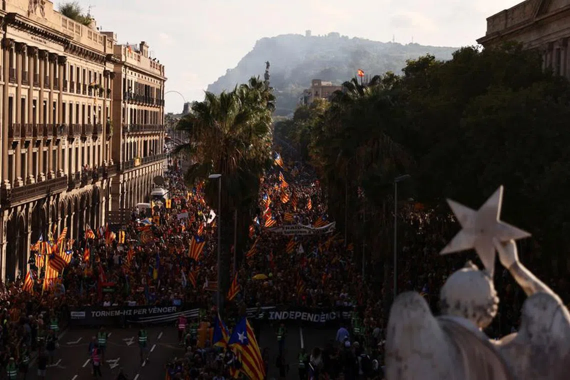 FILE PHOTO: People hold up Esteladas, or Catalan separatist flags, during a demonstration to mark Catalonia's national day 'La Diada' in Barcelona, Spain, September 11, 2022. REUTERS/Nacho Doce/File Photo