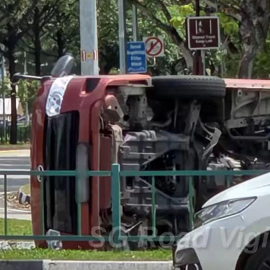 An orange van is seen lying on its side after the accident, which occurred at the junction of Buangkok Green and Buangkok Link on June 4.