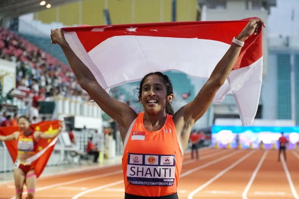 Shanti Pereira celebrates with the Singapore flag after winning the women's 100m final at the Asian Athletics Championships on Friday.