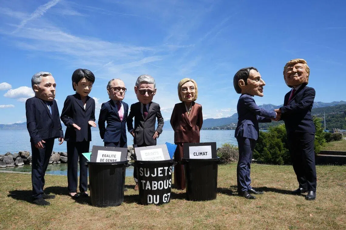 Demonstrators wearing masks in the likeness of G-7 world leaders during a protest ahead of the summit in Evian, France, on June 14.