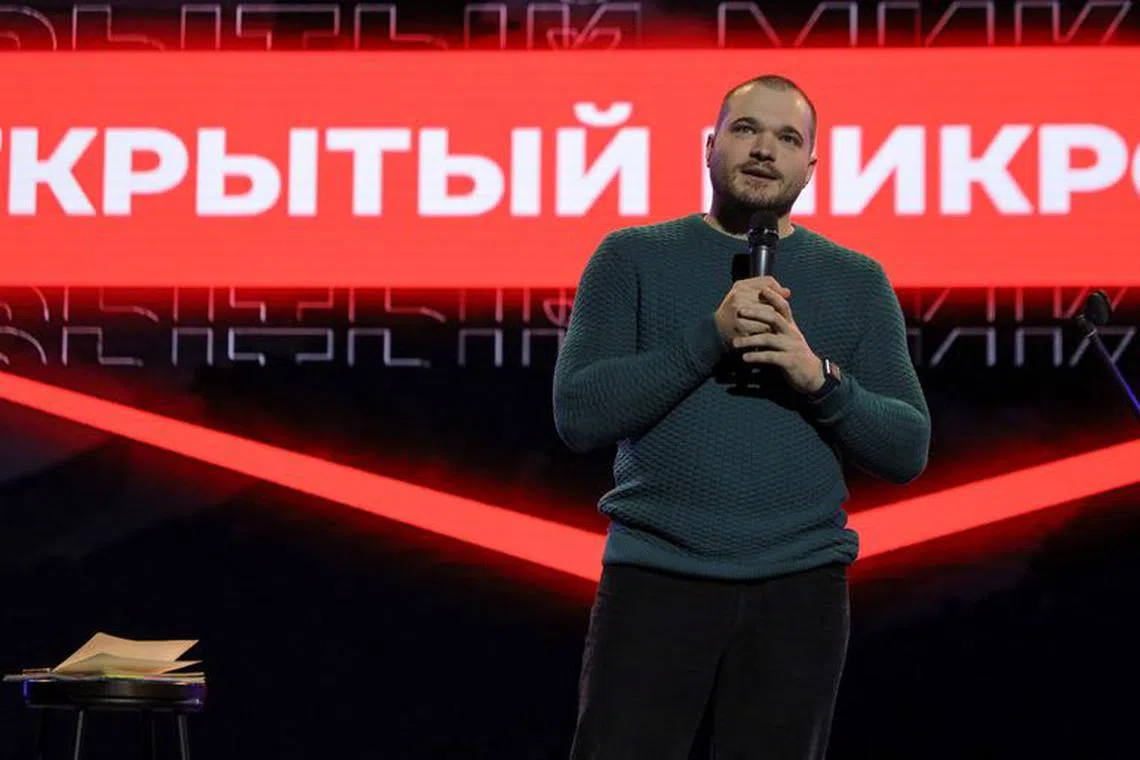 Stand-up comic Ivan Garkushko addresses the audience during his performance in Moscow, Russia, October 6, 2023. REUTERS/Lev Sergeev