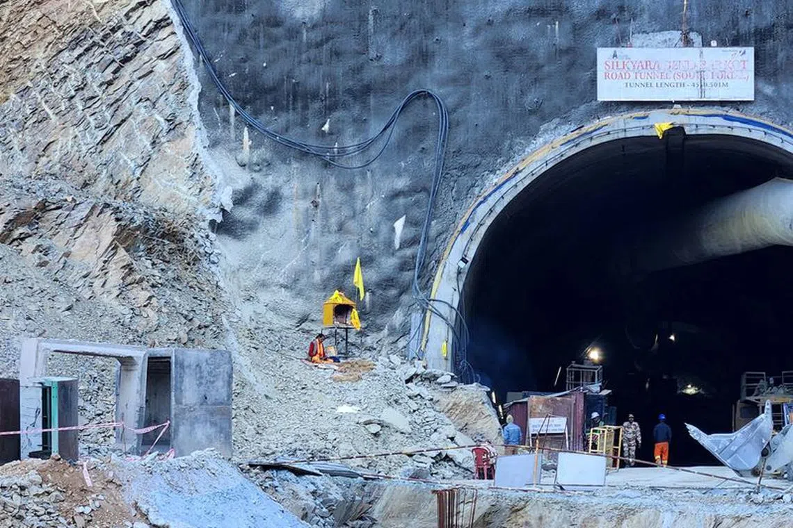 A Hindu priest prays at a makeshift shrine outside the entrance of a tunnel where workers are trapped after a portion of the tunnel collapsed in Uttarkashi in the northern state of Uttarakhand, India, November 21, 2023. REUTERS/Saurabh Sharma