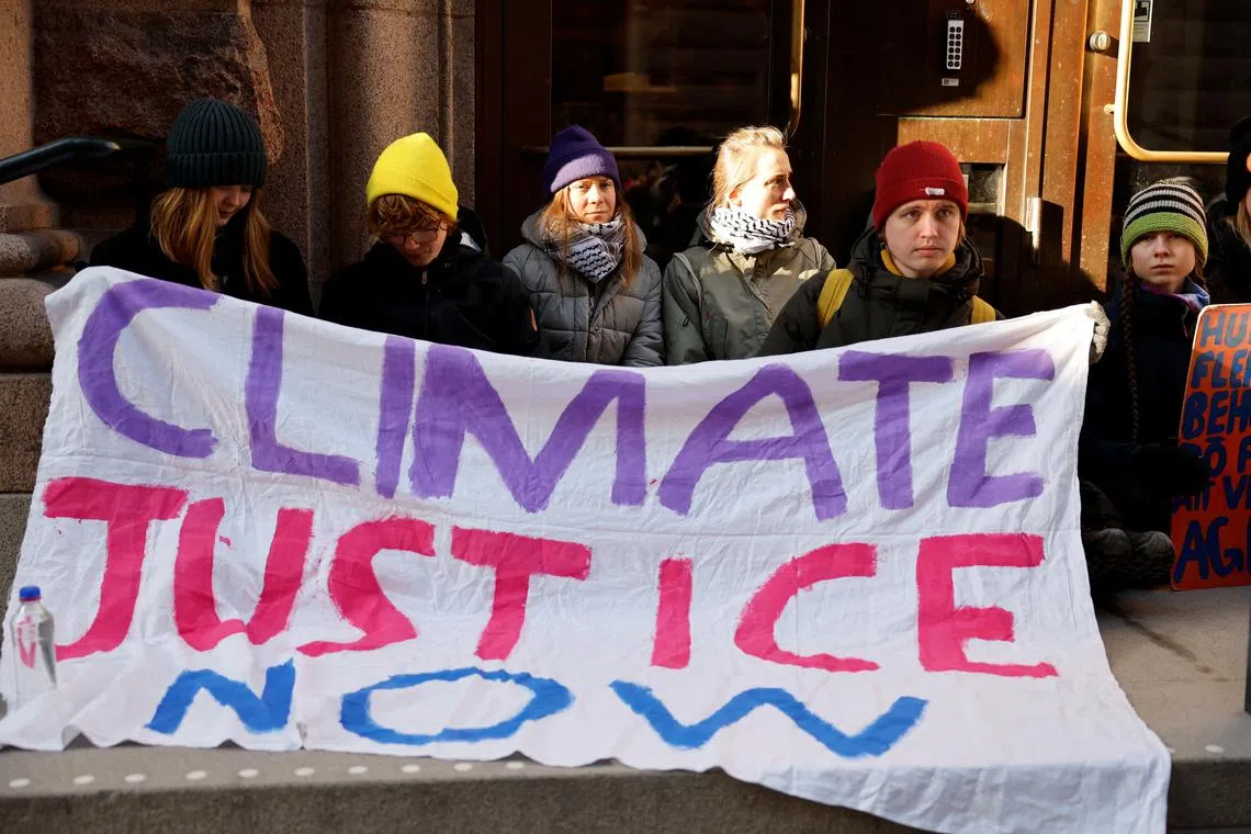 Climate activist Greta Thunberg blocks the entrance of the Swedish Parliament during a protest in Stockholm, Sweden March 11 2024. Christine Olsson/ TT News Agency/via REUTERS