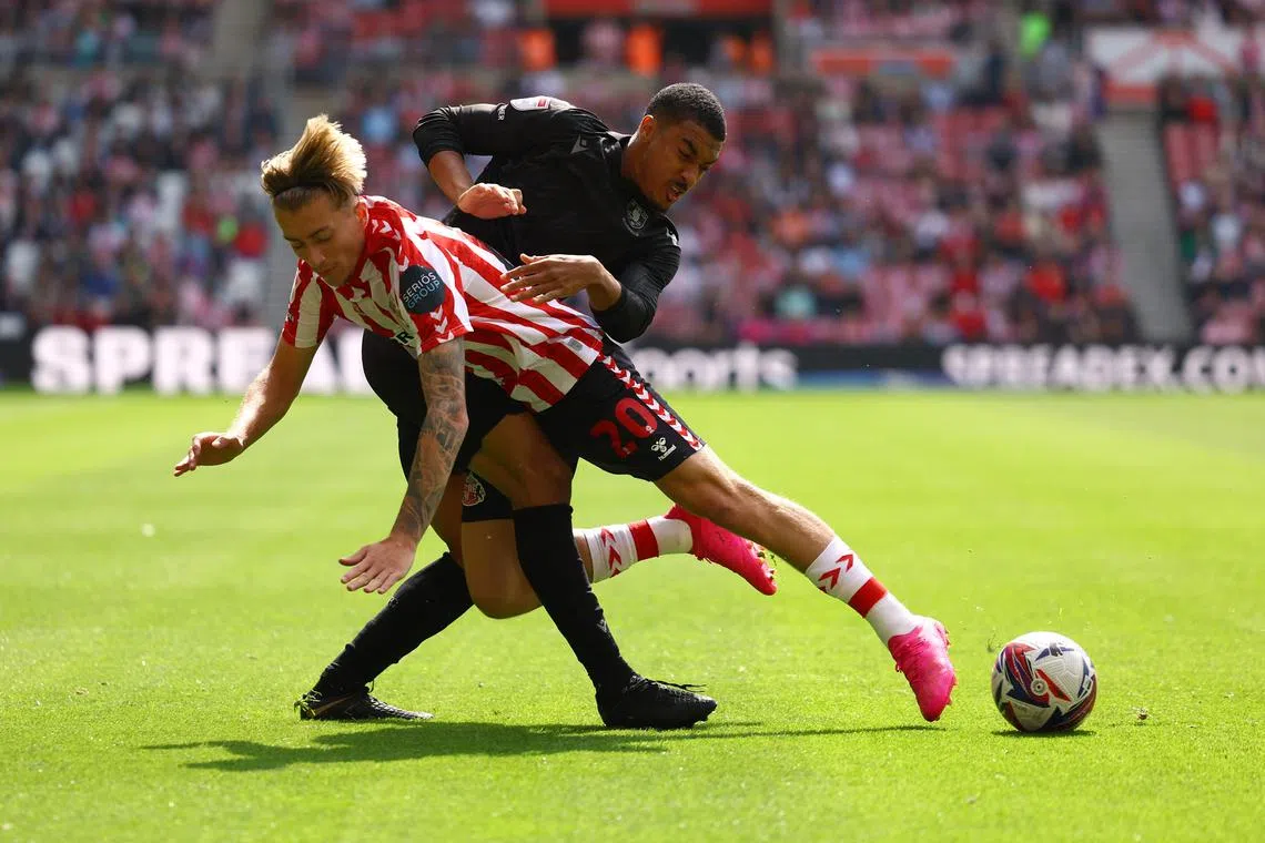 Soccer Football - Championship - Sunderland v Sheffield Wednesday - Stadium of Light, Sunderland, Britain - August 18, 2024 Sunderland's Jack Clarke in action with Sheffield Wednesday's Yan Valery Action Images/Lee Smith/File photo