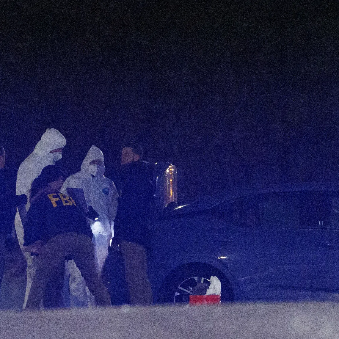 Investigators look at a grey Nissan car at a storage facility where the Brown University shooter, identified by authorities as Claudio Neves Valente, took his own life, in Salem, New Hampshire, U.S., December 18, 2025. REUTERS/CJ Gunther