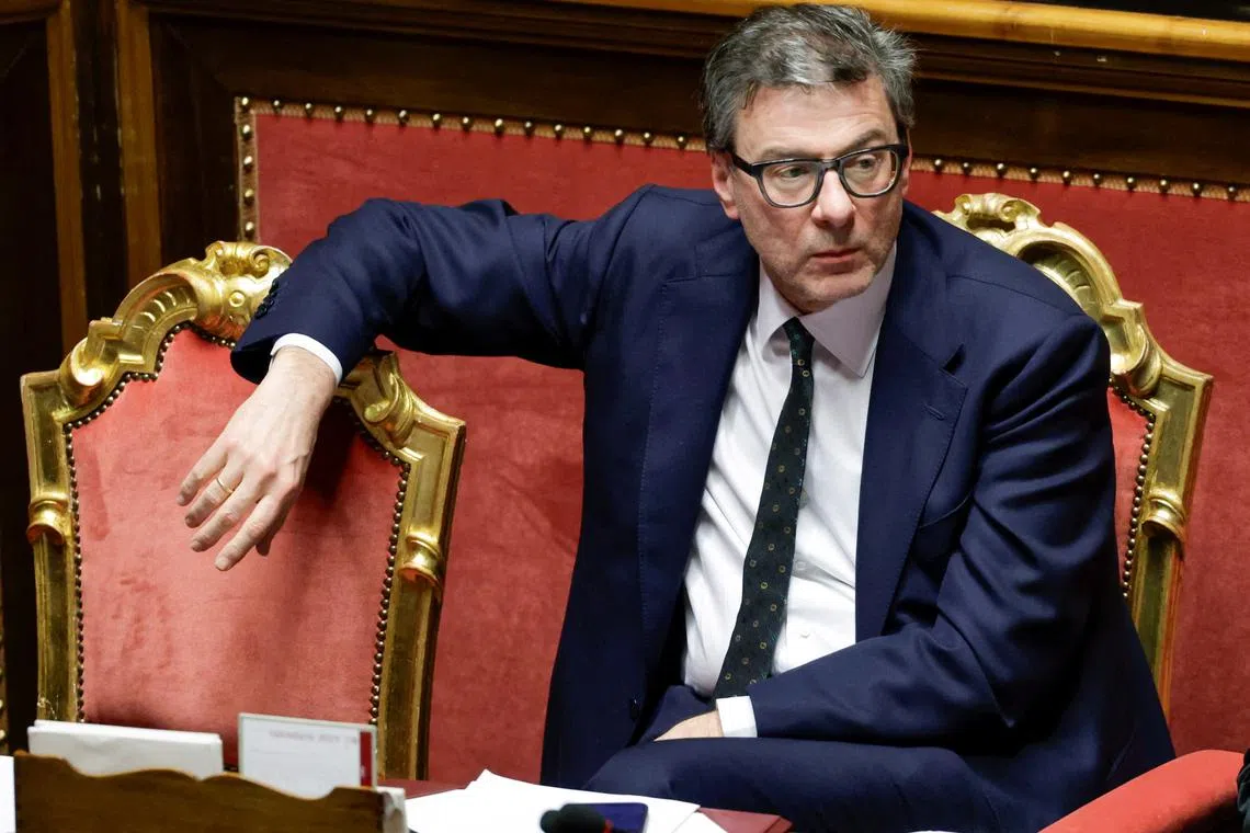 FILE PHOTO: Italy's Economy Minister Giancarlo Giorgetti looks on, as Italy's Prime Minister Giorgia Meloni appears at the upper house of the Parliament in Rome, ahead of a European Union leaders' summit, in Rome, Italy, March 18, 2025. REUTERS/Remo Casilli/File Photo
