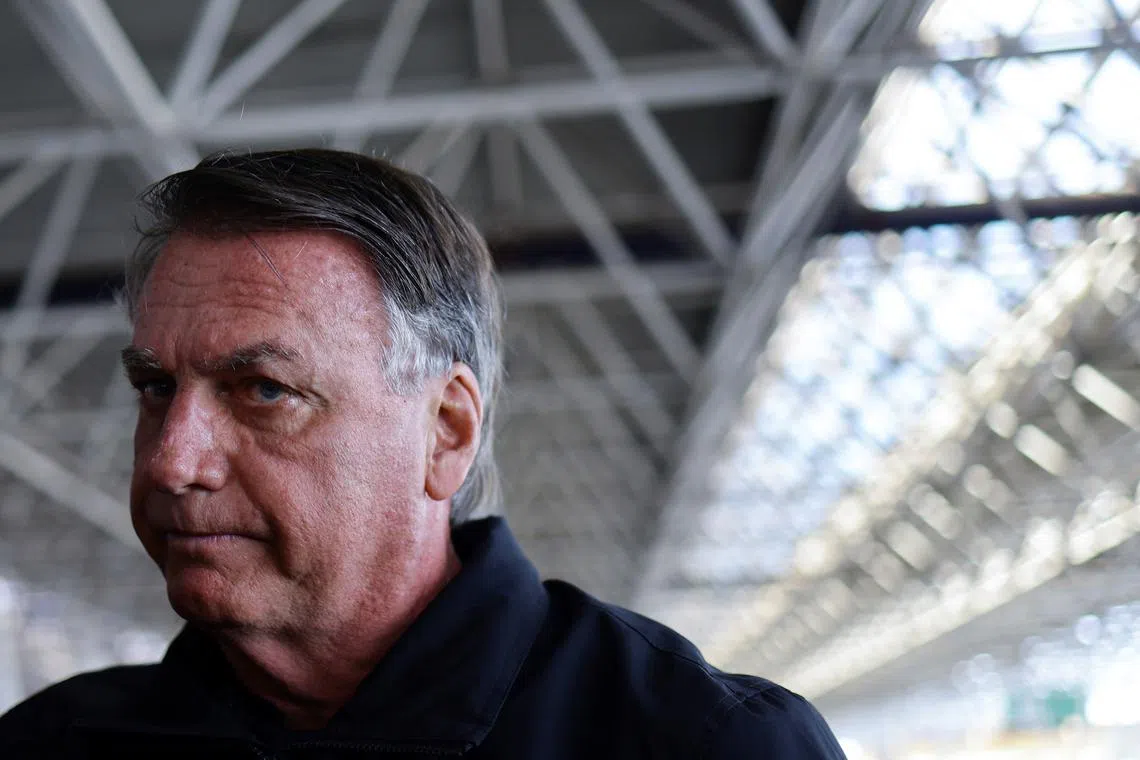 FILE PHOTO: Brazil's former President Jair Bolsonaro accompanied by his wife Michelle Bolsonaro (not pictured) arrive at Brasilia International Airport, as she departs for the inauguration of U.S. President Donald Trump, in Brasilia, Brazil, January 18, 2025. REUTERS/Ueslei Marcelino/File Photo