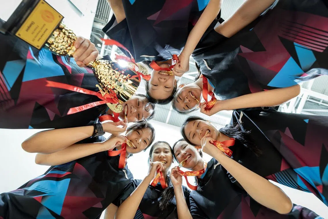 Nanyang Girls’ High School celebrating their National B Division Girls’s Badminton win against Raffles Girls’ School.



