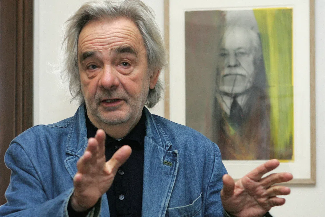 FILE PHOTO: Austrian artist Arnulf Rainer gestures as he poses for photographers in front of an overpainted portrait of psychoanalyst Siegmund Freud at Siegmund Freud Museum in Vienna November 22, 2006.  REUTERS/Herwig Prammer/File Photo