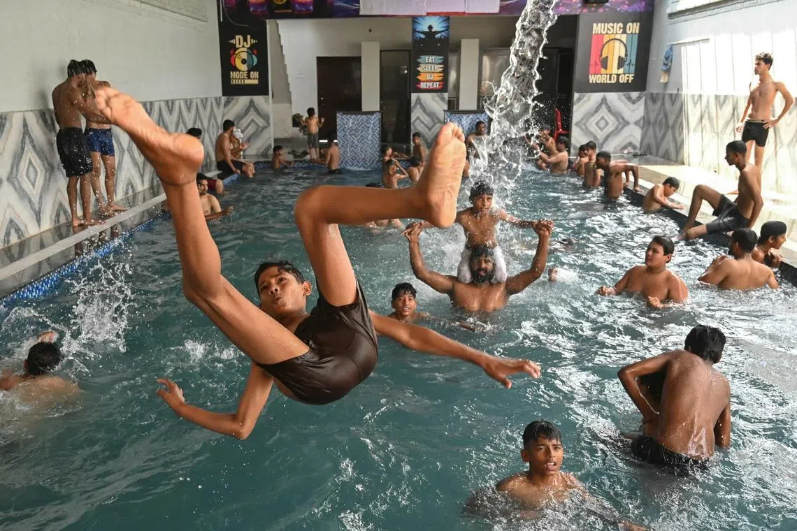 People cooling off at a swimming pool on a hot summer day in Amritsar, India, on June 8, 2025. 